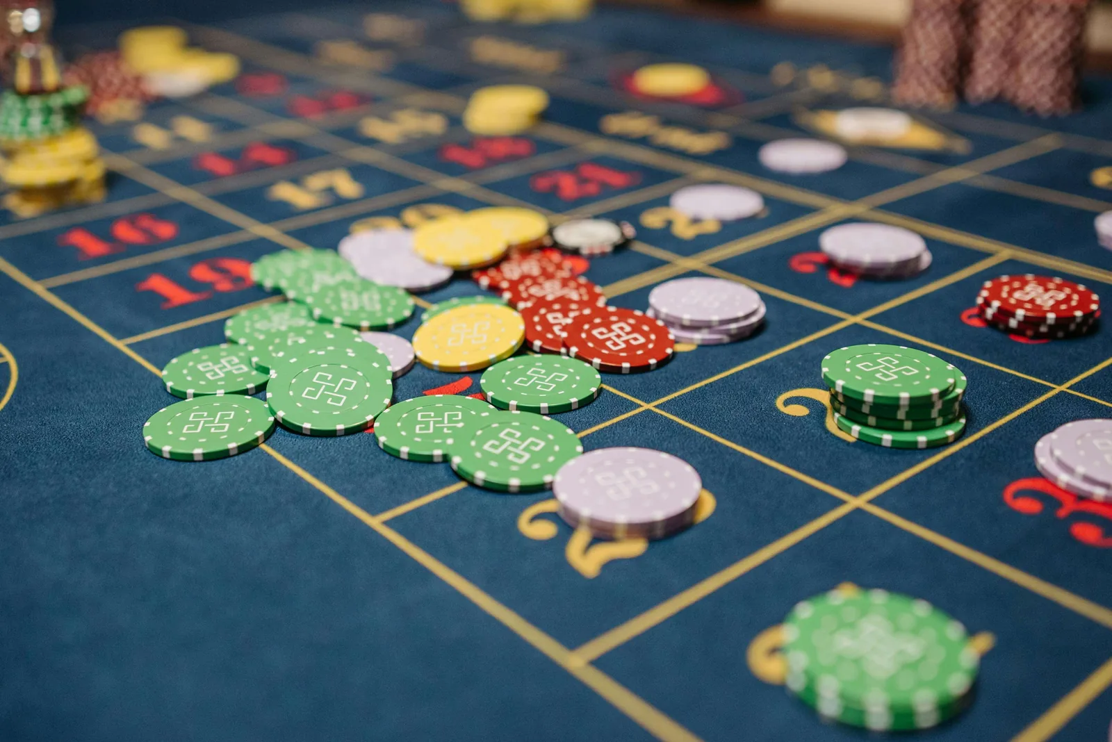 A roulette table in working condition, chips arranged across a navy Velvetine layout